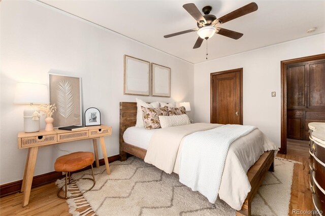 bedroom with ceiling fan and light wood-type flooring