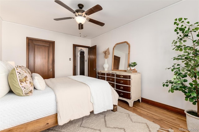 bedroom featuring hardwood / wood-style flooring and ceiling fan