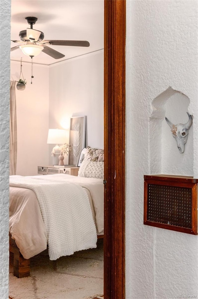 bedroom featuring ornamental molding, carpet flooring, and ceiling fan