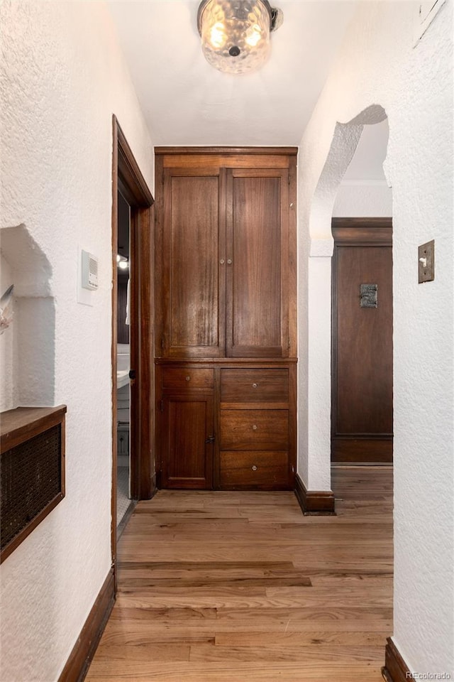 corridor featuring light hardwood / wood-style floors