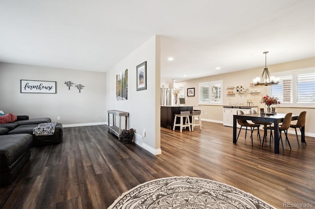 living room featuring dark wood-type flooring and a notable chandelier