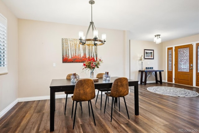 dining space with an inviting chandelier and dark hardwood / wood-style floors