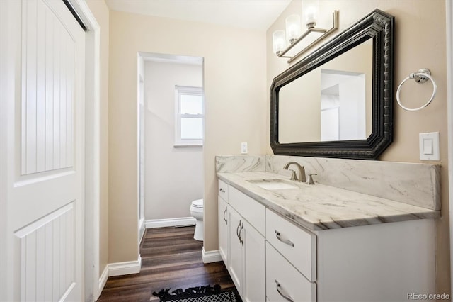 bathroom featuring vanity, toilet, and hardwood / wood-style floors