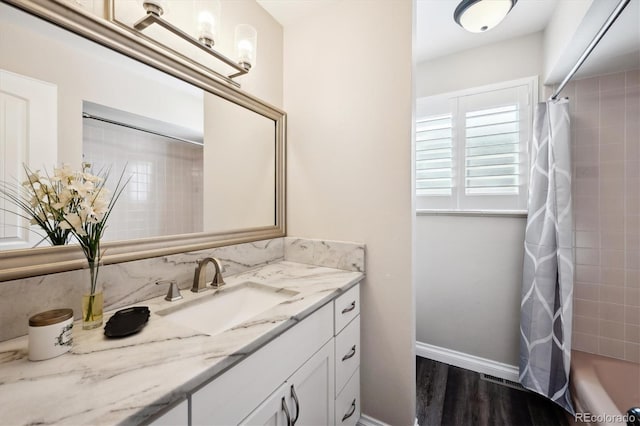 bathroom with shower / tub combo with curtain and vanity