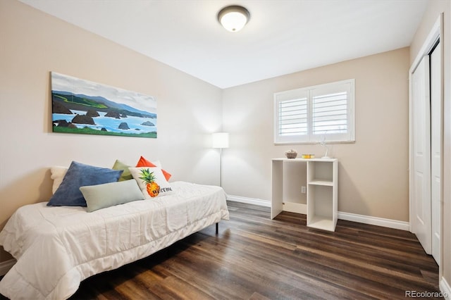 bedroom with a closet and dark hardwood / wood-style floors