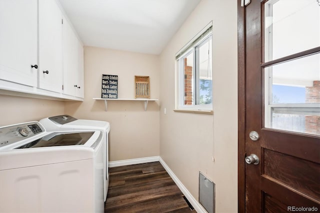 clothes washing area with cabinets, dark wood-type flooring, and independent washer and dryer