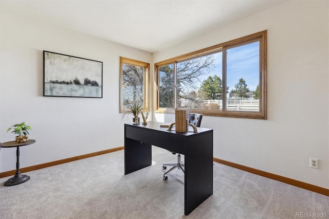 carpeted home office featuring baseboards