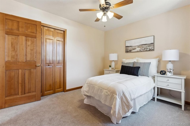 bedroom with light colored carpet, baseboards, and ceiling fan