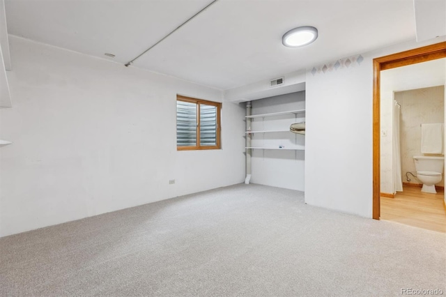 interior space featuring visible vents and carpet flooring