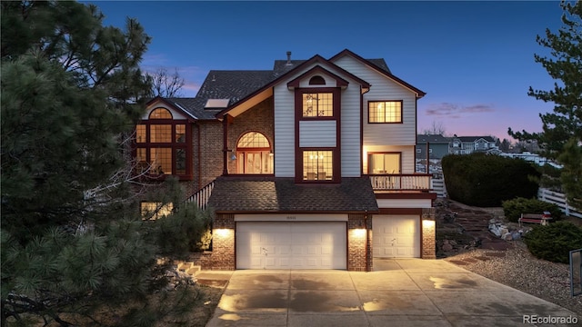 view of front of property with an attached garage, brick siding, driveway, and a shingled roof