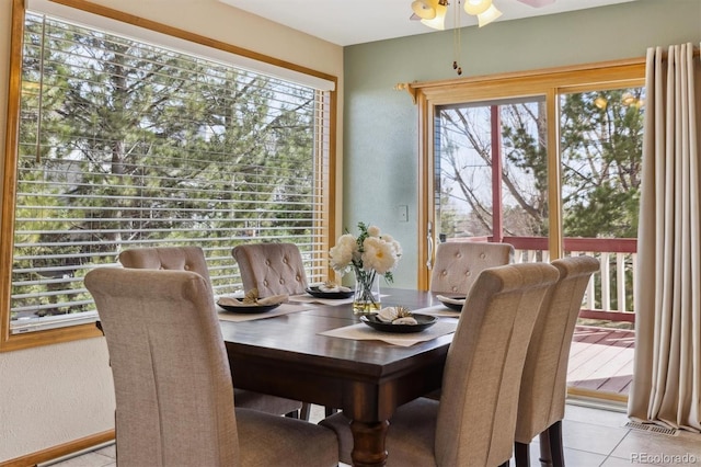 dining room with visible vents, light tile patterned flooring, a ceiling fan, and a textured wall