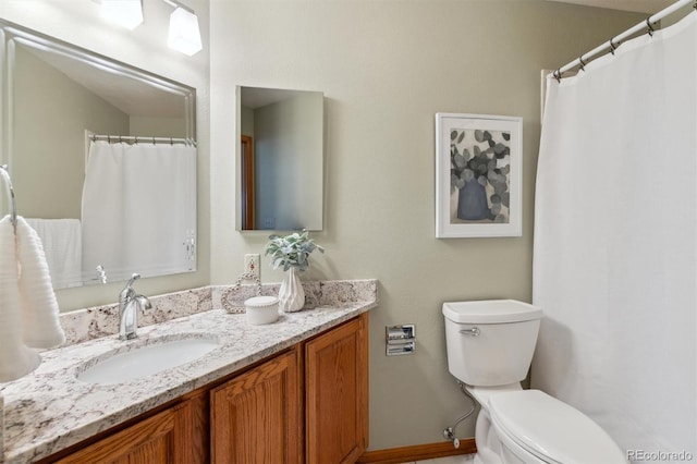 bathroom with toilet and vanity