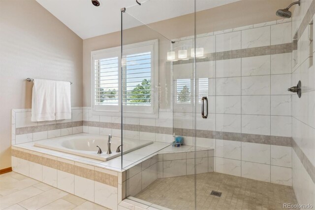 full bath with tile patterned flooring, a stall shower, a garden tub, and vaulted ceiling