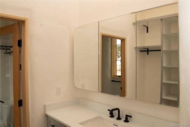 bathroom with toilet and vanity