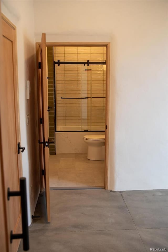 full bath with shower / bath combination, tile patterned flooring, and toilet