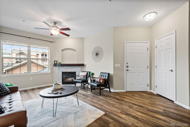 living room with ceiling fan and dark wood-type flooring