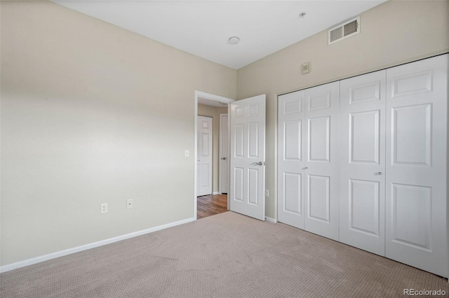 unfurnished bedroom featuring carpet floors and a closet