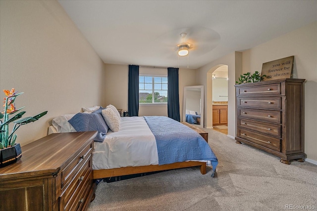23831 Eagle Bend Ln, Parker, CO 80138 - bedroom with light colored carpet, arched walkways, ensuite bath, a ceiling fan, and baseboards