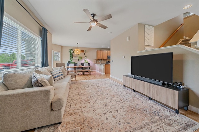 23831 Eagle Bend Ln, Parker, CO 80138 - living room with ceiling fan, light wood-type flooring, stairs, baseboards, and lofted ceiling