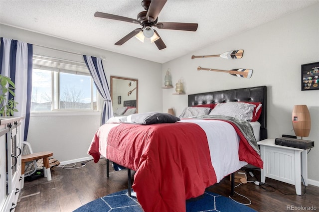 bedroom with ceiling fan, dark hardwood / wood-style floors, and a textured ceiling