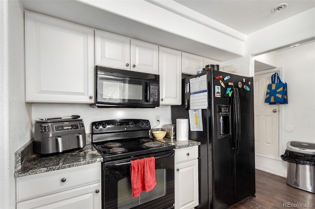 kitchen with dark stone counters, dark wood-type flooring, white cabinets, and black appliances