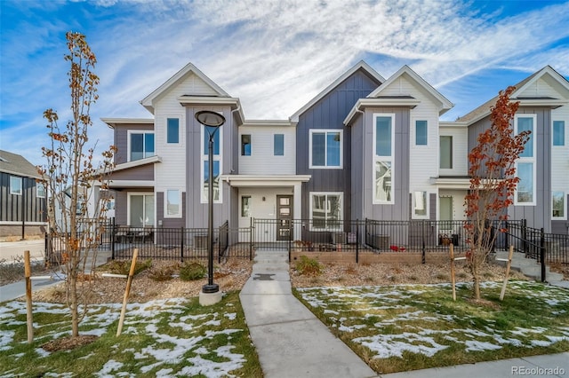 1983 S Poplar Ct, Denver, CO 80224 - townhome / multi-family property featuring board and batten siding and a fenced front yard