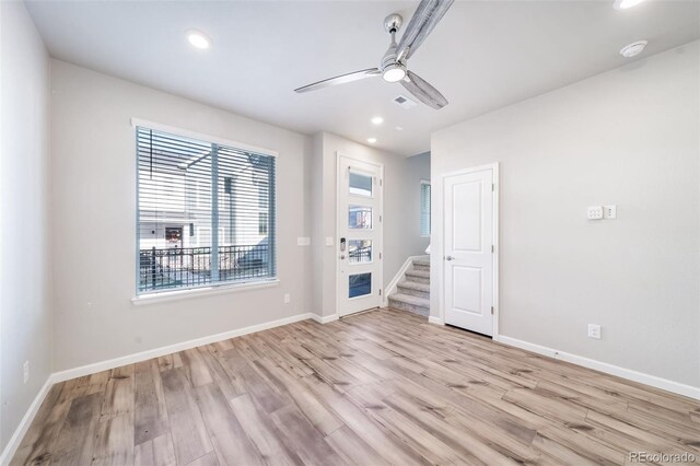 1983 S Poplar Ct, Denver, CO 80224 - empty room with light wood finished floors, a ceiling fan, recessed lighting, stairway, and a smoke detector
