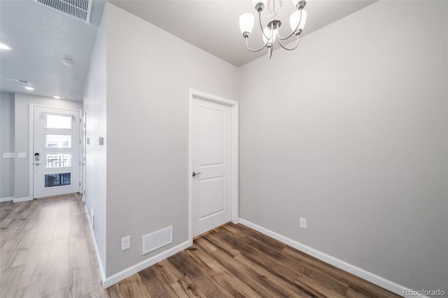 1983 S Poplar Ct, Denver, CO 80224 - unfurnished room featuring a chandelier and wood finished floors