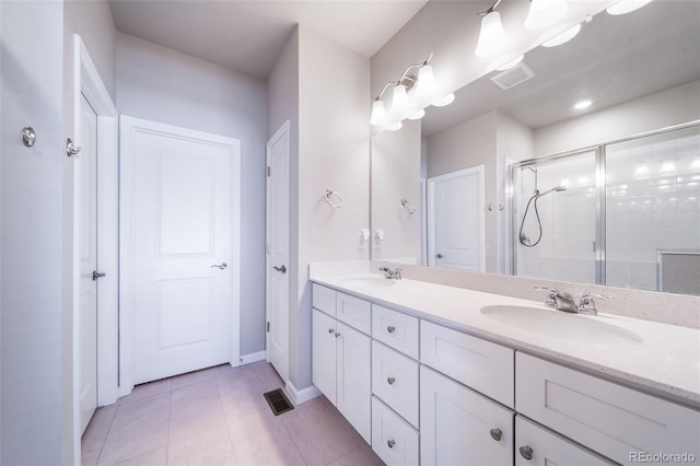 1983 S Poplar Ct, Denver, CO 80224 - bathroom featuring double vanity, a stall shower, and tile patterned flooring
