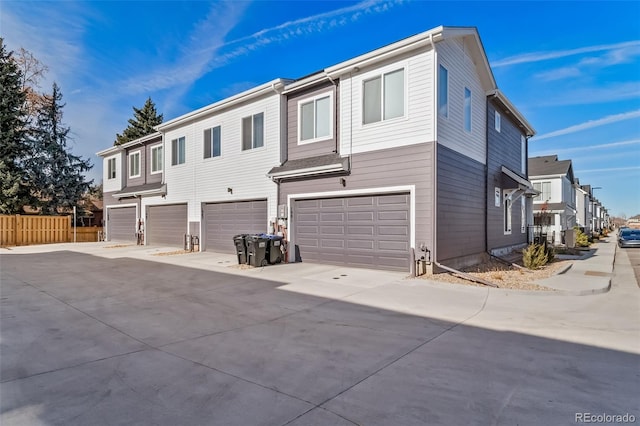 1983 S Poplar Ct, Denver, CO 80224 - view of front of home featuring an attached garage, driveway, and a residential view