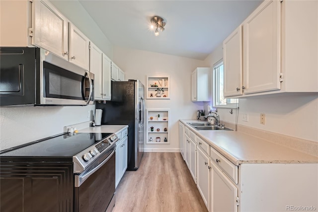 kitchen featuring sink, light hardwood / wood-style floors, white cabinetry, range with electric stovetop, and lofted ceiling