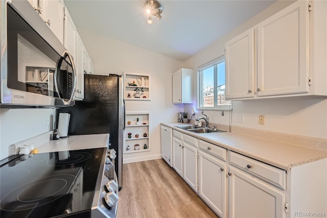 kitchen with range with electric cooktop, sink, white cabinets, and light hardwood / wood-style floors