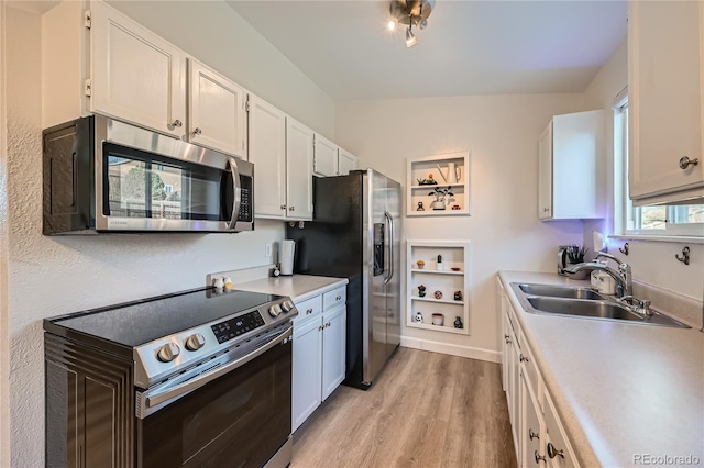 kitchen featuring white cabinets, appliances with stainless steel finishes, light hardwood / wood-style flooring, and sink