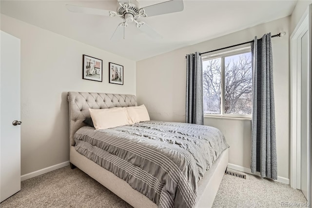 bedroom with ceiling fan and light carpet