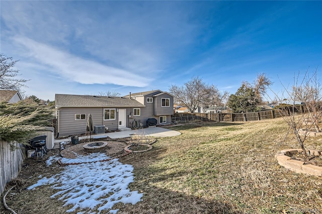 rear view of house featuring a yard, a patio, and an outdoor fire pit