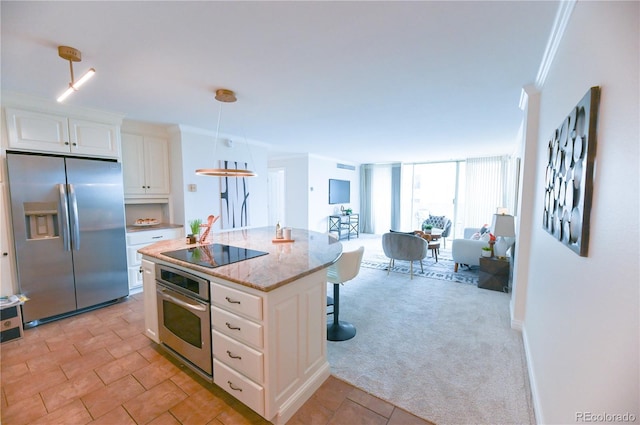 1020 15th St Unit 29L, Denver, CO 80202 - kitchen with appliances with stainless steel finishes, a breakfast bar area, white cabinetry, light stone countertops, and crown molding