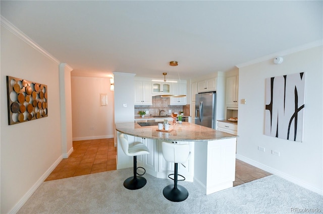 1020 15th St Unit 29L, Denver, CO 80202 - kitchen featuring stainless steel fridge with ice dispenser, white cabinetry, a kitchen bar, light stone countertops, and tasteful backsplash