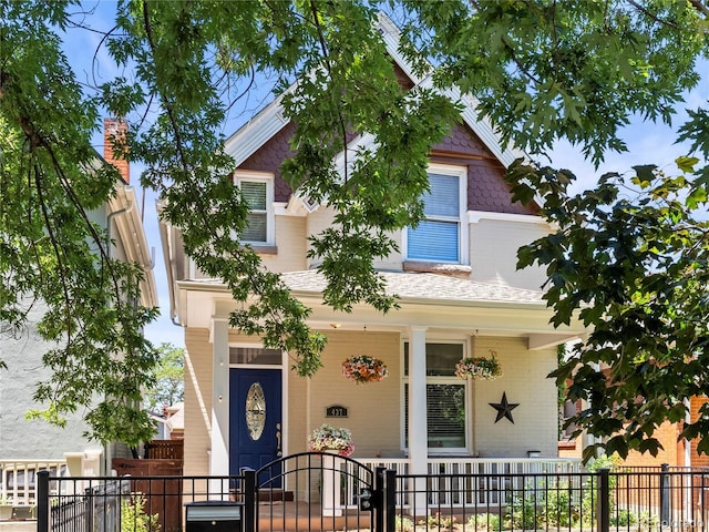 437 S Grant St, Denver, CO 80209 - view of front facade with covered porch and a fenced front yard