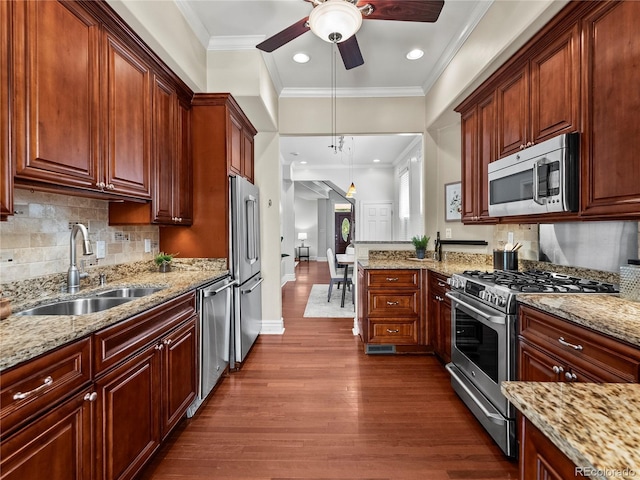 437 S Grant St, Denver, CO 80209 - kitchen with stainless steel appliances, dark wood-type flooring, a ceiling fan, light stone counters, and decorative backsplash
