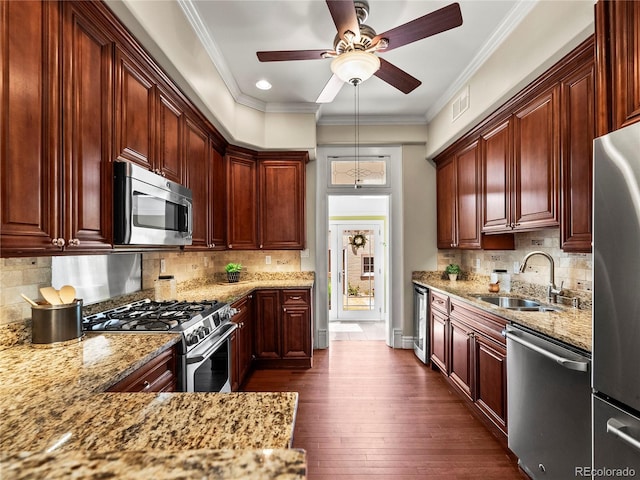 437 S Grant St, Denver, CO 80209 - kitchen featuring appliances with stainless steel finishes, light stone counters, a ceiling fan, tasteful backsplash, and crown molding