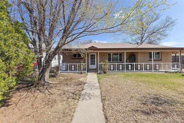 view of front of property featuring covered porch and brick siding