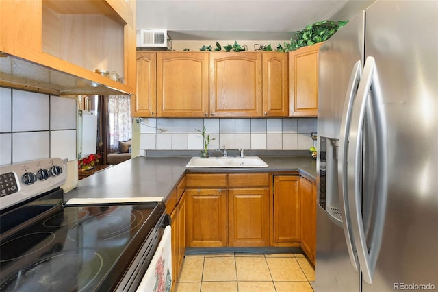 kitchen with light tile patterned floors, backsplash, a sink, visible vents, and appliances with stainless steel finishes