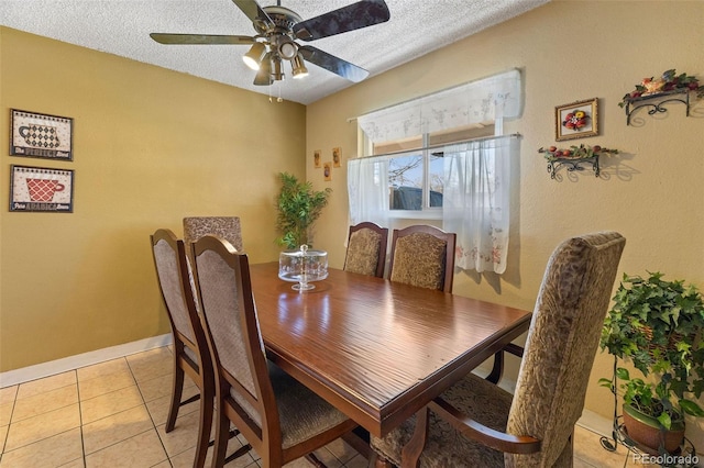 dining area featuring light tile patterned flooring, a textured ceiling, and ceiling fan