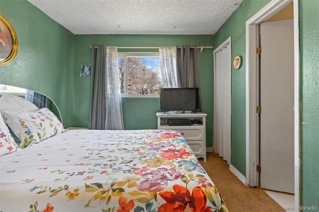 bedroom with a textured wall, carpet flooring, and a textured ceiling