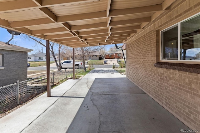 view of patio / terrace with fence and a residential view