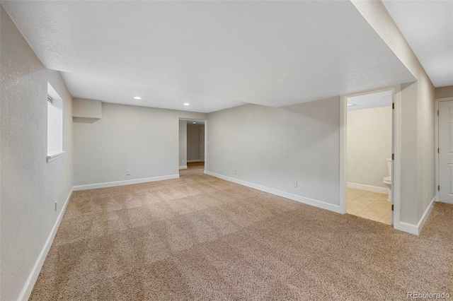 finished below grade area featuring carpet, baseboards, and recessed lighting