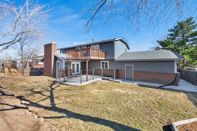 back of house with french doors, brick siding, a yard, a patio area, and a fenced backyard