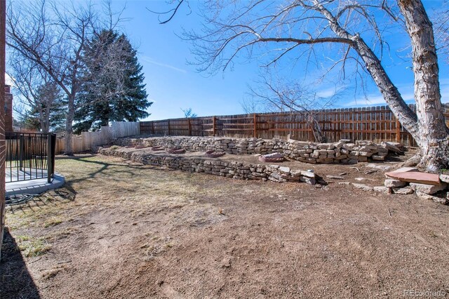 view of yard featuring a fenced backyard and a trampoline