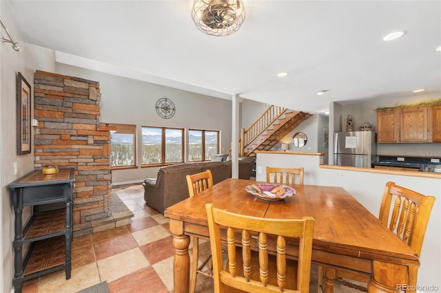 dining space featuring recessed lighting and stairs