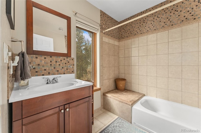 full bathroom with a bathtub, tile walls, vanity, and tile patterned flooring